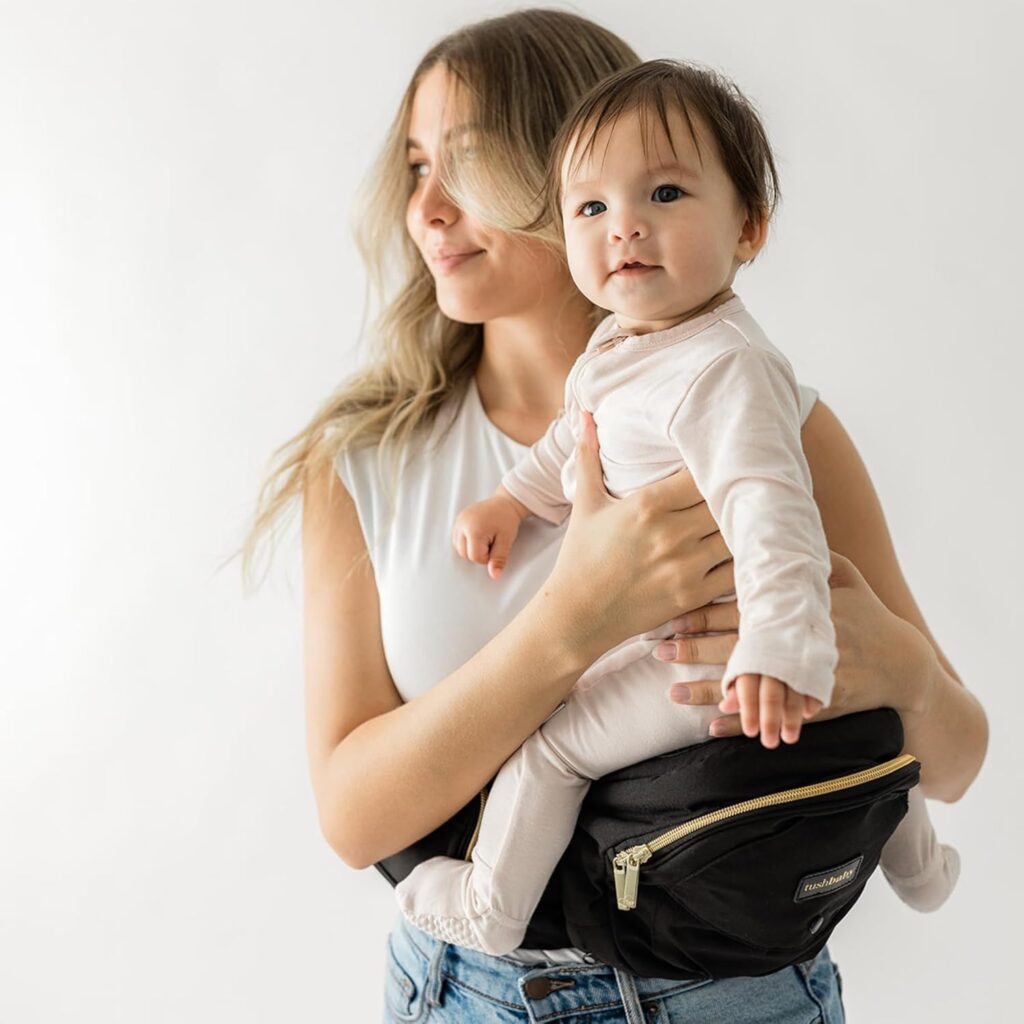 Top 5 Baby Hip Seat Carriers — Quick Comparison tushbaby original premium hip seat carrier in black and gold with storage pockets and ergonomic support
